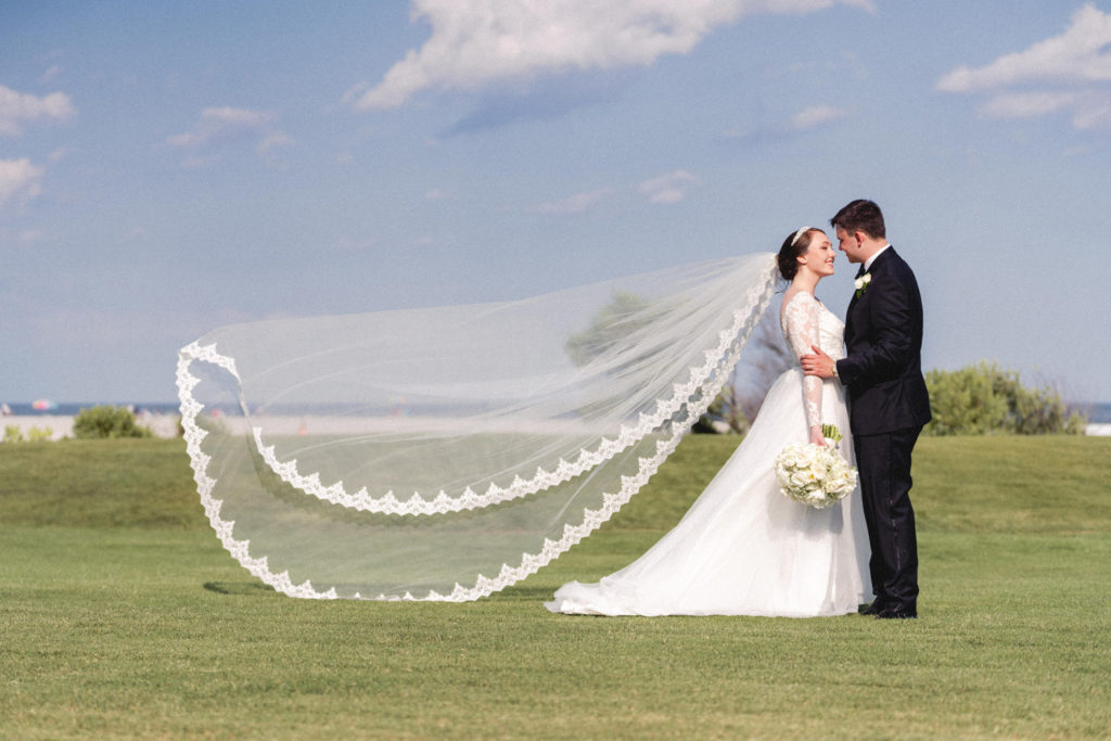 bride and groom flowing veil photo