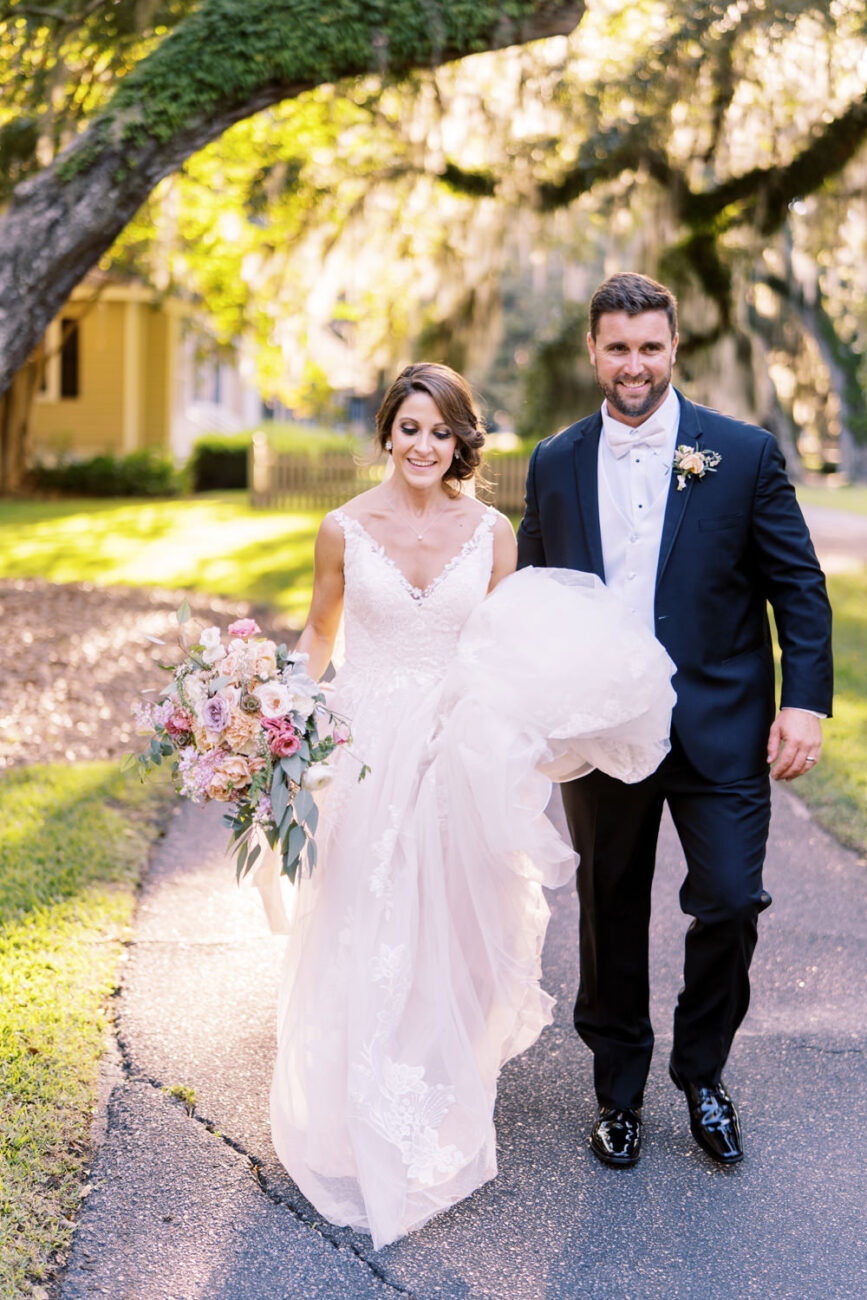 bride and groom walking at Wachesaw Plantation